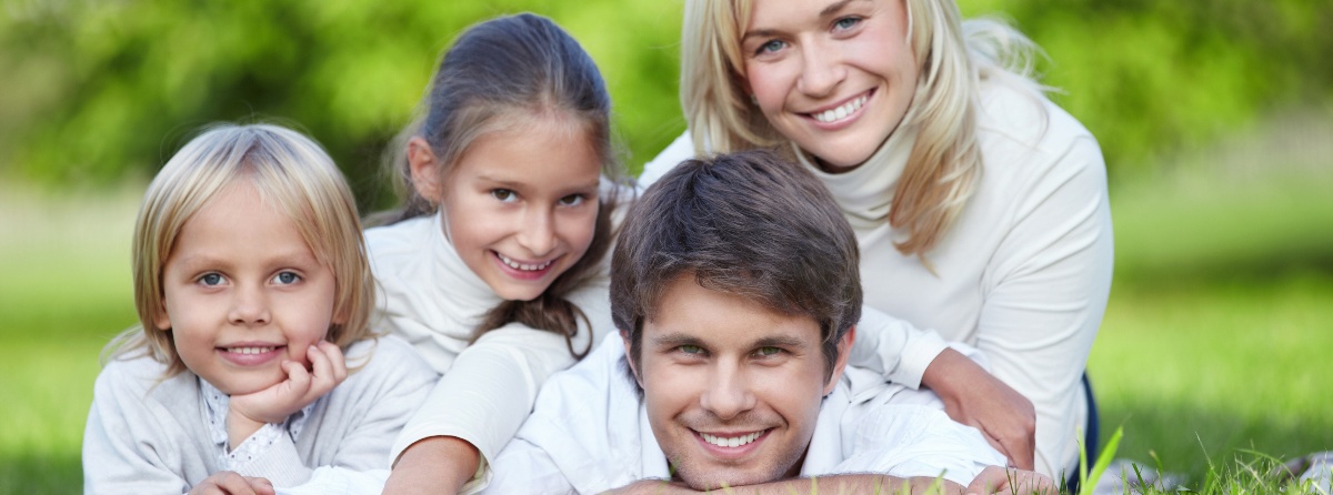 A happy family lying on the grass in the park
